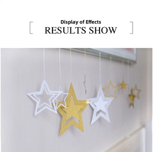 Close-up of glitter gold and silver hollow star hanging ornaments for festive wall decor