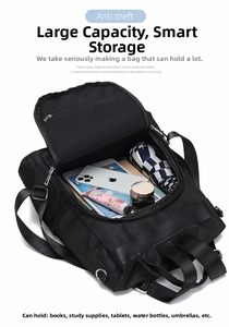 Internal view of a black nylon backpack showing large capacity storage with metal zippers