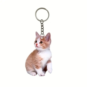 Detailed view of ginger and white cat acrylic keychain with durable metal ring for backpacks