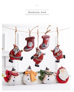 Close-up of vintage iron Christmas ornaments with Santa and Snowman hanging on twine