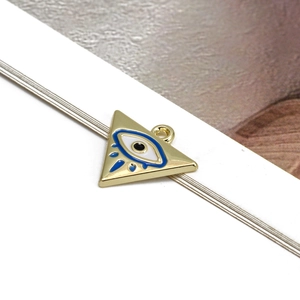 Close-up of golden triangle evil eye pendant with blue and white enamel for DIY jewelry