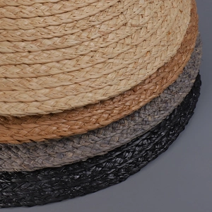 Detailed macro view showing the natural raffia straw weaving texture in multiple colors