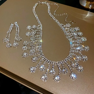 Detailed view of silver tassel necklace and earring set with shimmering zircons