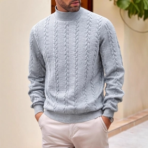 Men's light blue cable knit sweater with a turtleneck and long sleeves in outdoor setting