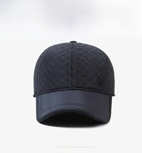 Front view of quilted navy baseball cap for men featuring a metallic logo detail