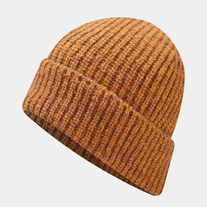 Detail of chunky ribbed knit texture on mustard yellow winter beanie for outdoor warmth