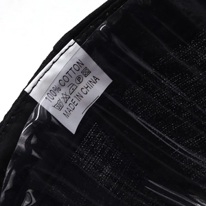 Close-up of 100% cotton baseball cap label showing washing symbols and made in China tag