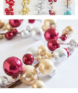 Macro shot of metallic Christmas bauble branches in various high-gloss colors for decor