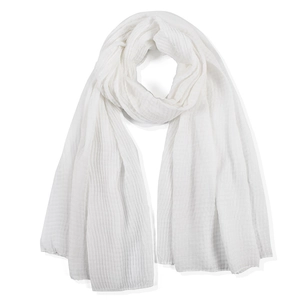 Close-up of white pleated cotton linen scarf showing soft crinkle texture and airy gauze fabric