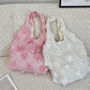 Detail of 3D rose flower appliqués on soft chiffon tote bags in pink and white