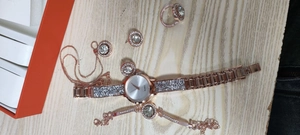 Luxury rose gold quartz watch set with rhinestone necklace and jewelry on wood texture
