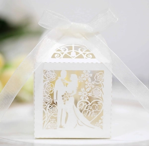 Detailed laser-cut white wedding favor box with Mr & Mrs text and organza ribbon