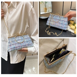 Detailed view of blue sequin crossbody bag showing metal handle and interior capacity