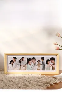Detail of light wood multi-frame for 5 vertical photos on lace tablecloth with tulips