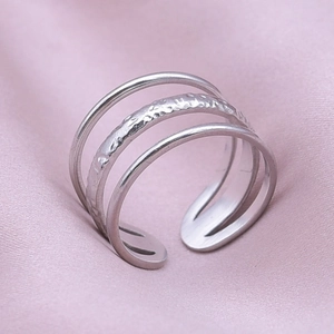Close-up of triple-layered stainless steel ring featuring textured hammered finish