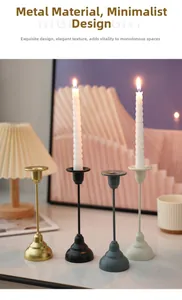 Detail of metal candle holders in gold, black, bronze, and white for elegant dining