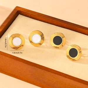Detail of 1.8cm gold earrings with hammered texture and black and white inlay