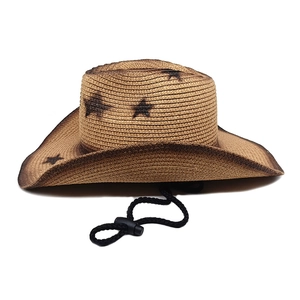 Detail of western woven straw hat featuring a black star print and adjustable chin strap