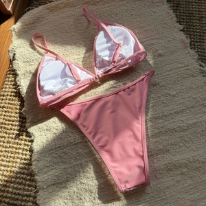 Detailed flat lay of pink sequin bikini set showing adjustable straps and soft inner lining