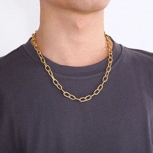 Close-up of a stylish gold titanium steel chain necklace worn by a male model