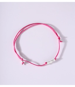 Detail of adjustable rose red woven bracelet with silver beads on pink background