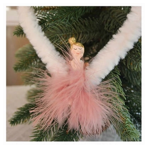 Detail of pink Christmas plush angel ornament with feather skirt hanging on tree branch