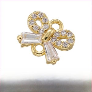 Detail of gold bow charm with micro-pave zircons for DIY jewelry making 7.5x9mm