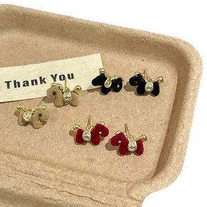 Three pairs of flocking puppy stud earrings in brown black and red with gold saddle details