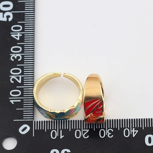 Size reference of adjustable gold rings with colorful enamel inlay and metric ruler