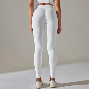 Detail of high waisted white seamless yoga pants with textured ribbing and booty lift design