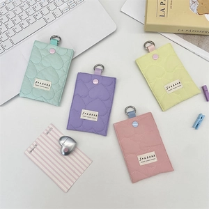 Detailed close-up of quilted heart card holders in mint, lilac, yellow, and pink colors