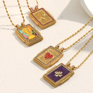 Detail of 18K gold plated rectangular pendant necklaces with colorful enamel patterns