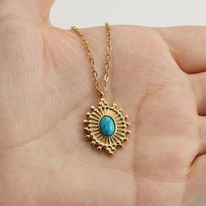 Handheld vintage 18K gold plated stainless steel necklace with blue turquoise sunburst pendant