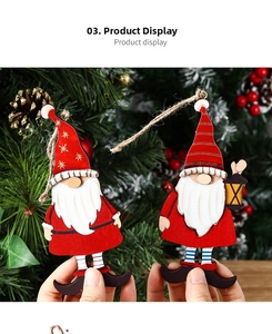 Detail of wooden Santa ornaments with red hats on a decorated Christmas tree
