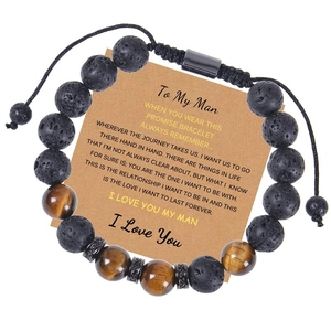 Macro shot of 10mm lava rock and tiger eye stone bracelet with adjustable woven cord