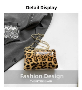 Detail of leopard print evening clutch with gold chain and rhinestone clasp