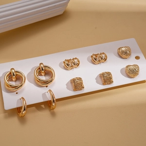 Detailed view of 6-pair gold earring set featuring textured heart and geometric studs