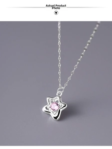 Macro detail of S925 sterling silver star pendant with pink cubic zirconia stone