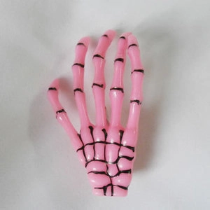 Detailed view of a pink Harajuku skeleton hand hair clip with gothic aesthetic style