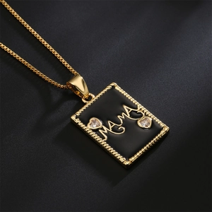 Gold 18K plated square MAMA pendant necklace with black enamel and zircons on black background