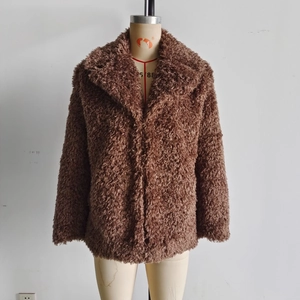Close-up of coffee brown faux fur coat showing curly plush texture and lapel design