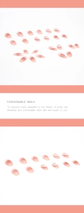Detail showing pink gradient press-on nails with cute red heart designs on white background