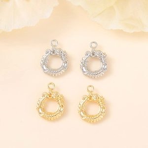 Detailed view of circular dragon pendants in polished gold and silver metal finishes