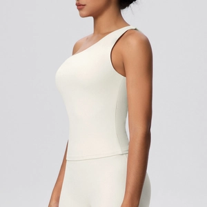Detail shot of white one-shoulder sports bra showing seamless elastic fabric and fit