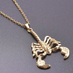 Detailed view of a golden 18K stainless steel scorpion pendant with necklace chain