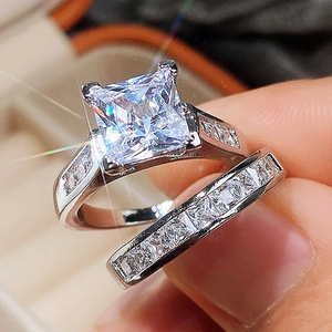 Close-up of a two-piece set featuring a princess cut zircon ring with a matching band