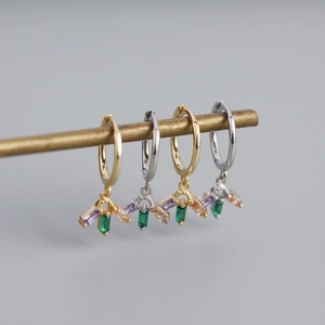 Close-up of geometric S925 silver hoop earrings with multicolored zircon stone pendants