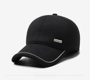 Detail of black baseball cap with metallic Fashion plate and curved brim on thick fabric