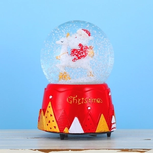 Detailed view of red Christmas snow globe with Santa and white deer on a blue background