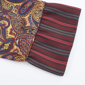 Detail of paisley print shirt with red and green stripe patchwork and satin texture